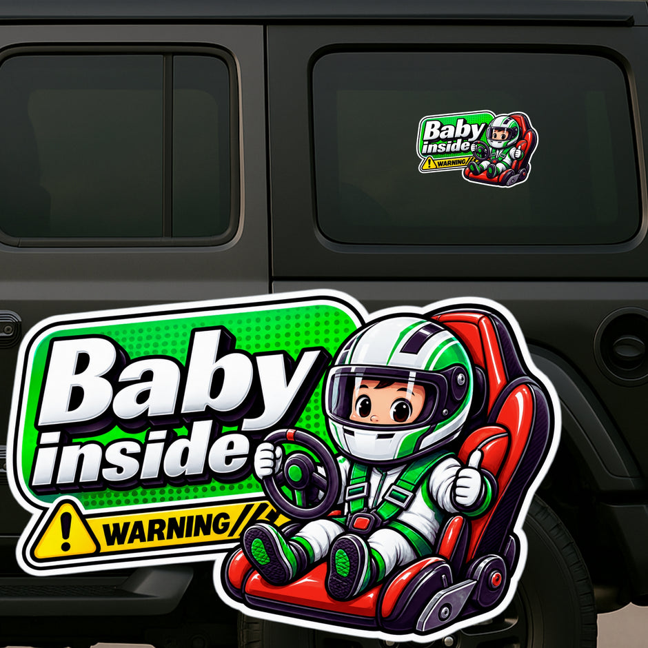 A die-cut vinyl sticker featuring a cartoon baby driver in a red go-kart with the text 'Baby inside' and a warning label, shown applied to the rear window of a dark vehicle. A smaller version of the same sticker is visible on the upper right window.